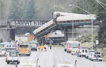  ?? Picture: Reuters ?? LATEST DISASTER. Rescue personnel and equipment at the scene where an Amtrak passenger train derailed on a bridge in DuPont, Washington in the US on Monday.