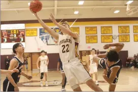  ?? Photo by Becky Polaski ?? Michael Jacobs, 22, was fouled on this play and would use a three-point play to give the Crusaders a 40-29 lead with one minute remaining in the third quarter.