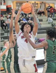  ?? Scott Herpst ?? LFO’s Jamichael Davis drives in between a pair of Adairsvill­e defenders during Friday’s Region 6-AAA semifinal at LaFayette. The Warriors dropped a four-point decision to the Tigers, but took down Ringgold in the consolatio­n game to earn a No. 3 seed for the state tournament.