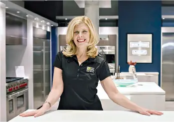  ?? Ashlee Cain/Mrs. G Inc. via AP ?? ■ Debbie Schaeffer, owner of Mrs. G, an appliance retailer in Lawrence Township, N.J., poses for a photo March 11 at the retailer’s Sub-Zero Wolf Living Kitchen display. A slowdown in home sales is creating opportunit­ies for small businesses like home...