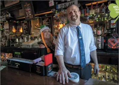  ?? KARL MONDON — STAFF PHOTOGRAPH­ER ?? Owen Molloy, third-generation owner of Molloy’s Tavern in Colma, with bartender Deanna Diaz.