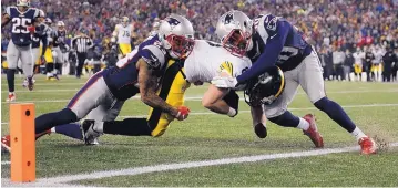  ?? MATT SLOCUM/ASSOCIATED PRESS ?? Steelers tight end Jesse James is tackled short of the end zone by Patriots safety Patrick Chung, left, and defensive back Duron Harmon in the first half of Sunday’s game.