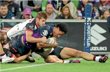  ?? PHOTO: GETTY IMAGES ?? Felise Kaufusi of the Melbourne Storm scores the winning try against the Warriors in their NRL match last night.