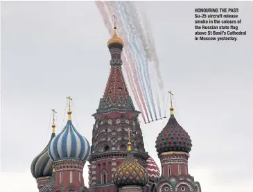  ??  ?? HONOURING THE PAST: Su-25 aircraft release smoke in the colours of the Russian state flag above St Basil’s Cathedral in Moscow yesterday.