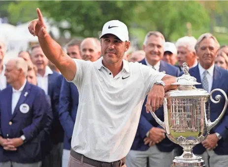  ?? ERIC GAY/AP ?? Brooks Koepka celebrates with the Wanamaker Trophy after winning the PGA Championsh­ip golf tournament Sunday at Oak Hill Country Club.