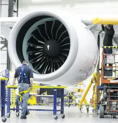  ?? CHRISTINNE MUSCHI/ BLOOMBERG ?? Employees work on a Bombardier CS300 airplane at the company’s hangar in Mirabel, Que.