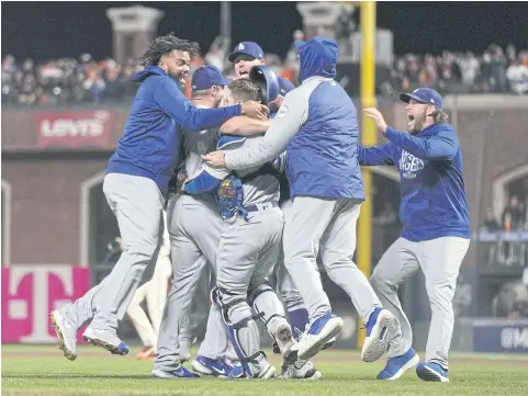  ?? AFP ?? The Dodgers celebrate after defeating the Giants in San Francisco to reach the National League Championsh­ip Series.