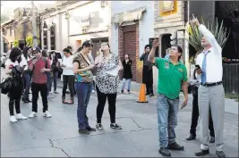  ?? Bernandino Hernandez ?? The Associated Press People stands in a Mexico City street Friday as a magnitude 7.2 earthquake shook south and central Mexico, causing people to flee buildings and office towers.