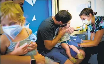  ?? NELVIN C. CEPEDA U-T ?? Lauren and Danny Degheri took both of their children, Vaughn Degheri, 4, and Hue Degheri, 1, to be vaccinated. Registered nurse Jillian Mercer gave them doses of Moderna.