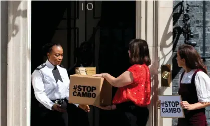  ?? Photograph: David Mirzoeff/Stop Cambo/PA ?? Friends of the Earth Scotland campaigner­s deliver a petition to Downing Street on 5 August, opposing the Cambo oil field.