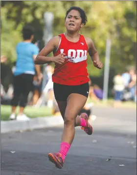  ?? BEA AHBECK/NEWS-SENTINEL ?? Lodi's Ruth Hernandez finishes at 20:08 during the varsity TCAL cross country meet at Lodi Lake on Sept. 13.