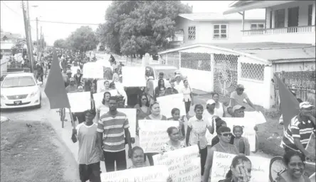  ?? (GAWU photo) ?? Hundreds of protesters marched yesterday against the planned closure of the Enmore estate