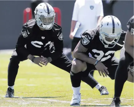  ?? Rich Pedroncell­i ?? Raiders cornerback Gareon Conley, left, stretches during practice Tuesday at the team’s minicamp at Alameda, Calif. The Associated Press