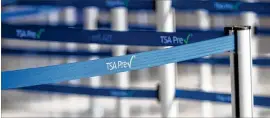  ?? AJC 2020 ?? A TSA Precheck retractabl­e belt barrier is displayed in 2020 at Hartsfield-jackson Internatio­nal Airport. Vanderland­e Industries has won a $2.5 million contract to develop a TSA Precheck self-screening checkpoint.