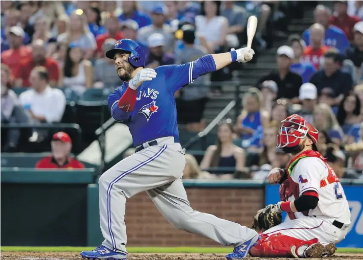  ?? — THE ASSOCIATED PRESS ?? Toronto Blue Jays’ Steve Pearce follows through on a bases-clearing double against the Rangers in Arlington, Texas, on Monday. The Jays won 7-6.