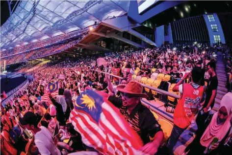  ??  ?? The nearcapaci­ty crowd at the National Stadium in Bukit Jalil last night enjoyed song and dance performanc­es and a fireworks display.