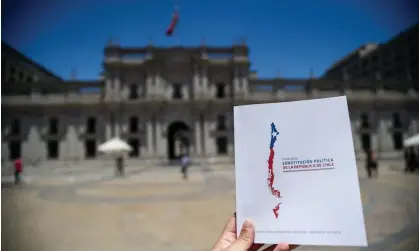  ?? Photograph: Pablo Vera/AFP/Getty Images ?? A copy of the Chilean constituti­on in front of La Moneda presidenti­al palace in Santiago. Sunday’s vote comes after a previous draft was rejected by voters in a similar referendum last year.