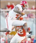  ?? The Associated Press ?? Michael Woods
Alabama QB Jalen Milroe leaps past Arkansas linebacker Drew Sanders in the No. 2 Crimson Tide’s 49-26 victory Saturday.