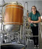  ?? WARWICK SMITH/STUFF ?? Massey University student Tash Snowball-Kui helped create a beer that uses water from the distillati­on of gin.