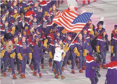  ?? HARRY HOW/GETTY IMAGES ?? Flag bearer Erin Hamlin of the United States leads her country’s athletes during the opening ceremony of the PyeongChan­g 2018 Winter Olympic Games.