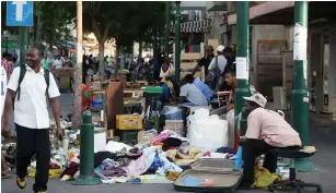  ?? (Marc Israel Sellem/The Jerusalem Post) ?? MIGRANTS LOITER on Levinsky Street near the Tel Aviv Central Bus Station in 2013.