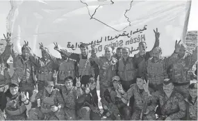  ??  ?? U.s.-backed Syrian Democratic Forces fighters gather for a photo after declaring victory over the Islamic State group on Saturday. STR/EPA-EFE