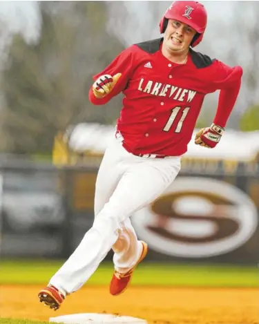  ?? STAFF PHOTO BY ERIN O. SMITH ?? Lakeview-Fort Oglethorpe’s Matthew Trusley rounds third base during Friday’s Region 6-AAA game at Sonoravill­e.