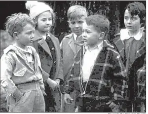  ??  ?? Special to the Democrat-Gazette A young Don Tyson, in the plaid jacket, plays the leader of a gang of children in The Kidnappers Foil, which was filmed in Springdale in 1937. The film was rediscover­ed last year and can now be found at the Library of...