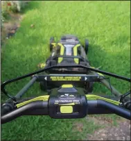  ??  ?? Self-propulsion adds expense to an electric mower but can make mowing a hilly yard much easier. (Special to the Democrat-Gazette/Janet B. Carson)