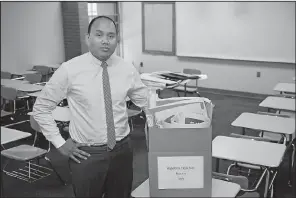  ?? AP/SUE OGROCKI ?? Former high school teacher Shawn Sheehan poses for a photo in the classroom where he once taught algebra in Norman, Okla. Sheehan, a former Teacher of the Year, has joined the exodus of Oklahoma teachers and has moved to Texas to teach in better...