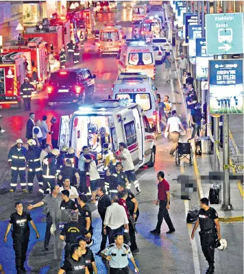  ??  ?? Paramedics treat the wounded at the scene of yesterday’s suicide bombing at Istanbul’s Ataturk airport, which killed at least 28