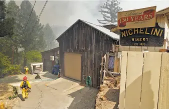  ?? Carlos Avila Gonzalez / The Chronicle ?? CalFire crews protect structures at the Nichelini Winery in Napa’s Chiles Valley on Tuesday.