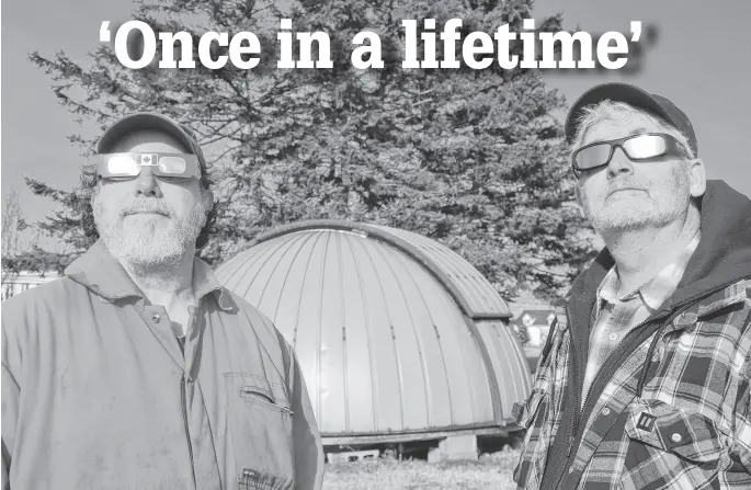  ?? CONTRIBUTE­D ?? Athena Community Astronomy Club (ACAC) members John Nangreaves, left, and Michael Nesbitt test out protective glasses provided for club members ahead of the April 8 total solar eclipse.