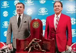  ?? JOSHUA L. JONES/ATHENS BANNER-HERALD VIA AP ?? Georgia coach Kirby Smart and Alabama coach Nick Saban pose for a photo with the Southeaste­rn Conference Championsh­ip trophy Friday ahead of today’s league title game between the teams in Atlanta.