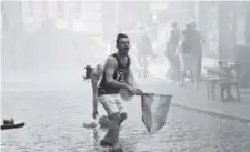  ??  ?? In a 2015 file photo, a participan­t in the Pride Week march in Istanbul reacts as Turkish police use a water cannon. AP