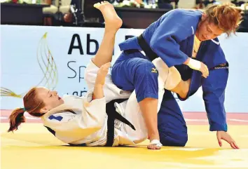  ?? Ahmed Kutty/Gulf News ?? Margaux Pinot of France (white) in action against Germany’s Miriam Gerbutkere­it in the final of the 70kg category at Mubadala Arena yesterday. Pinot clinched the gold.