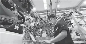  ?? PROVIDED TO CHINA DAILY ?? A technician writes the program for a robot bound for export in Hefei, capital of Anhui province.