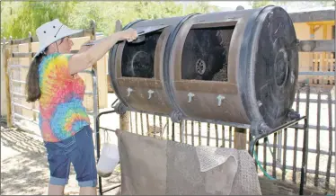  ??  ?? Skye Gibbins is closing up the compost tumbler and getting ready to turn it and mix up the materials. This also aerates the compost.