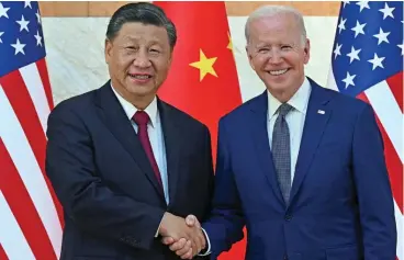  ?? (AFP) ?? US President Joe Biden (right) and China’s President Xi Jinping shake hands as they meet in Nusa Dua on the island of Bali on Monday