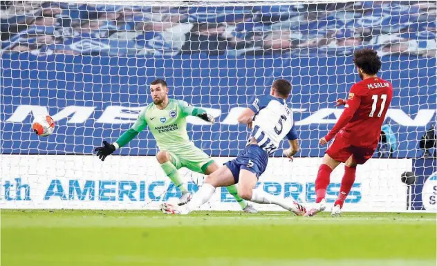  ?? Associated Press ?? ↑
Liverpool’s Mohamed Salah (right) scores against Brighton during their English Premier League match in Brighton on Wednesday.