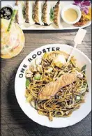  ?? CONTRIBUTE­D BY MIA YAKEL ?? One Rooster Mongolian Bar lo mein bowl with calamari, veggies, ginger teriyaki sauce, and seared salmon fillet.