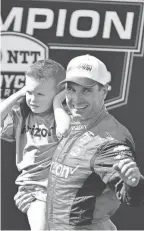  ?? GARY A. VASQUEZ/USA TODAY SPORTS ?? Team Penske driver Will Power, of Australia, with son Beau William, celebrates his series victory following the Grand Prix of Monterey at Weathertec­h Raceway Laguna Seca.