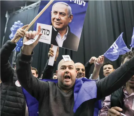  ?? (Marc Israel Sellem/The Jerusalem Post) ?? LIKUD SUPPORTERS celebrate the election results Monday night in Tel Aviv.