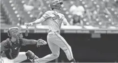  ?? RON SCHWANE/AP ?? The Reds' Tyler Naquin hits a single against the Guardians during the eighth inning Thursday in Cleveland.