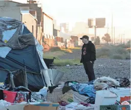  ?? MARK HENLE/THE REPUBLIC ?? Ollie Nyman, Community Bridges, Inc. associate director, checks a shelter during Maricopa County’s annual Point-in-Time count on Jan. 24 near 27th Avenue in Phoenix.