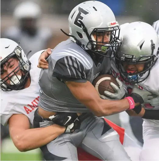  ?? KIRSTEN STICKNEY/SUN-TIMES ?? Clark’s Glenn Harris finds tough sledding against Nicholas Prestipino (right) and Victor Sosa as Amundsen’s defense pitched a shutout Friday.