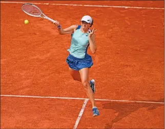  ?? Associated Press ?? Forehand: Poland's Iga Swiatek slams a forehand to Alison Riske of the U.S. during their second round match of the French Open tennis tournament at Roland Garros stadium Thursday in Paris.