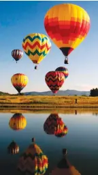  ?? — AFP ?? (Right) Balloons at Bald Eagle Lake during the 36th Annual Hot Air Balloon Rodeo in Steamboat Springs, Colorado on Sunday.