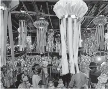  ?? KAKADE] ?? Lanterns are displayed for sale as people shop ahead of Diwali festival in Mumbai, India, on Thursday. India's tally of coronaviru­s cases is currently the second largest in the world behind the United States. The government warns that the situation can worsen due to people crowding markets for festival shopping. [AP PHOTO/RAJANISH