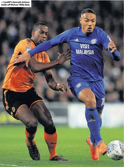  ??  ?? > Cardiff’s Kenneth Zohore holds off Wolves’ Willy Boly